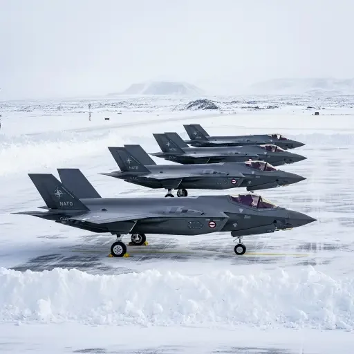 Danish F-35 fighter jets stationed at Keflavik Air Base, Iceland, with snowy runway and NATO insignia visible, photographed January 15, 2026