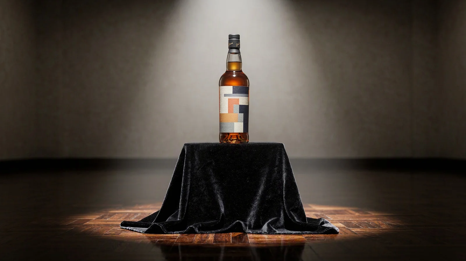 Single sealed whisky bottle on a velvet pedestal in an empty auction preview room under one spotlight